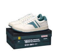 a white and teal sneaker on top of a box