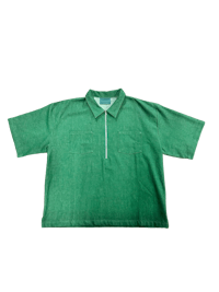 a green polo shirt on a black background